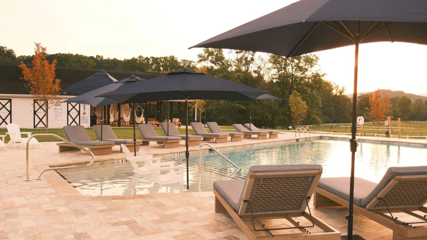 The estate pool at golden hour with the barn behind